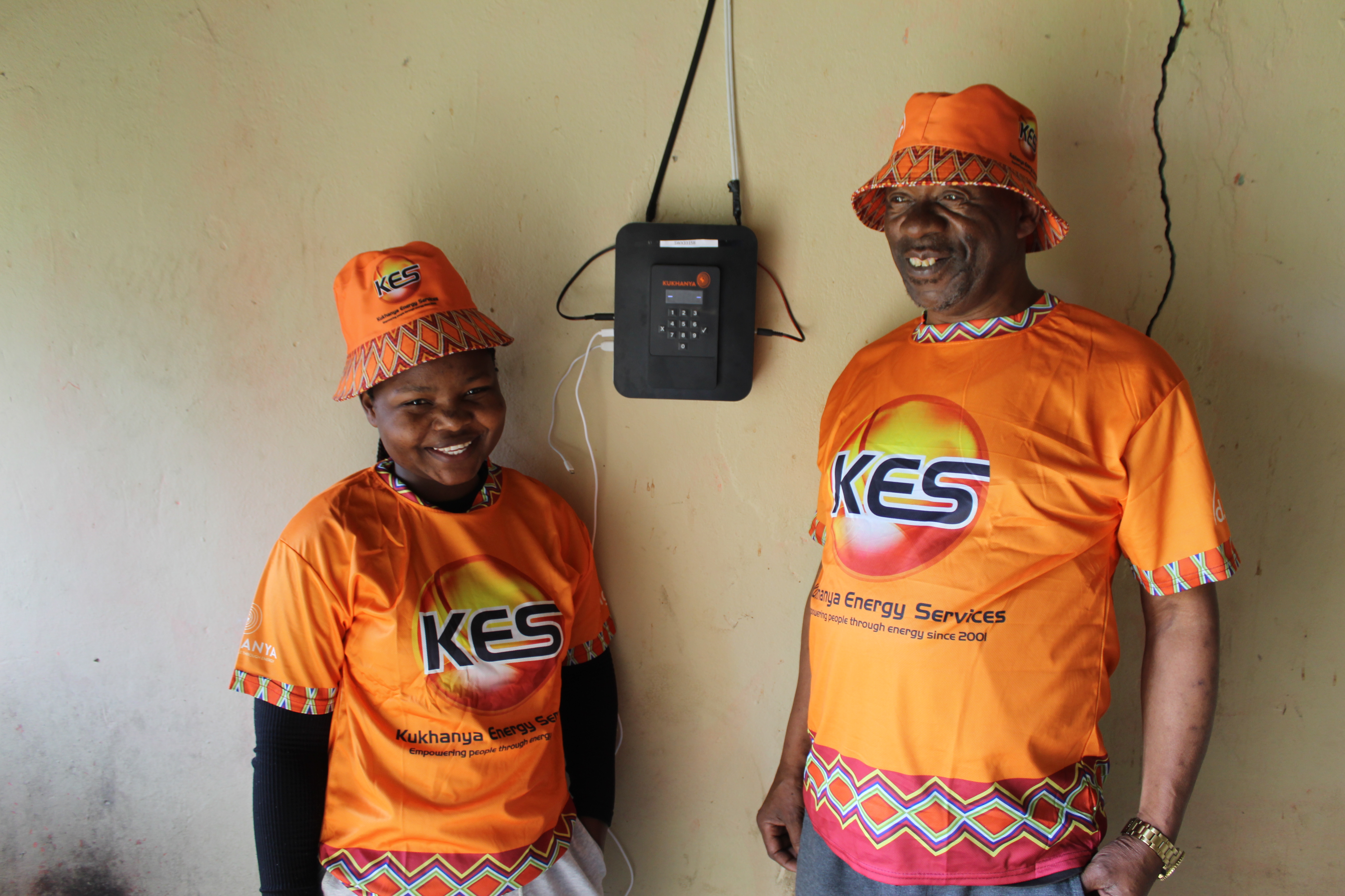 A Kukhanya Energy technician showing a customer her installed solar system